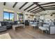 Open-concept living room and kitchen featuring hardwood floors, exposed beams, and plenty of natural light at 10160 E Whispering Wind Dr, Scottsdale, AZ 85255