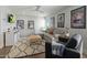 Cozy living room with a sectional sofa, decorative rug, and entertainment area, creating a comfortable living space at 10160 E Whispering Wind Dr, Scottsdale, AZ 85255