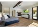 Comfortable main bedroom with fireplace, hardwood floors, and neutral decor at 10160 E Whispering Wind Dr, Scottsdale, AZ 85255
