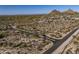 Paved street leading to luxury homes in a tranquil desert setting with mountain views in the distance at 10160 E Whispering Wind Dr, Scottsdale, AZ 85255