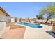 This backyard features a swimming pool, brick patio, and lush landscaping at 10438 W Butler Dr, Peoria, AZ 85345