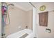 A tiled tub/shower combo features updated fixtures and a white shower curtain at 10438 W Butler Dr, Peoria, AZ 85345
