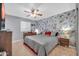 Bedroom features stylish accent wall, ceiling fan, and tiled floors at 10438 W Butler Dr, Peoria, AZ 85345