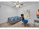 Bedroom features a ceiling fan, chair and desk at 10438 W Butler Dr, Peoria, AZ 85345