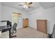 Bright bedroom featuring a ceiling fan, neutral carpet, and a window to the backyard at 10438 W Butler Dr, Peoria, AZ 85345
