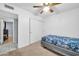 This bedroom features a ceiling fan, closet, and an adjacent room at 10438 W Butler Dr, Peoria, AZ 85345