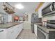 Bright kitchen boasts stainless steel appliances, island, and tile flooring at 10438 W Butler Dr, Peoria, AZ 85345