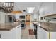 Well-lit kitchen features stainless steel appliances, a spacious island, and ample storage at 10438 W Butler Dr, Peoria, AZ 85345