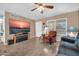 Relaxing living room featuring wood floors, a large television, and lots of natural light at 10438 W Butler Dr, Peoria, AZ 85345