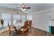 Bright dining room with a ceiling fan, wood flooring, and large windows for ample natural light at 111 S Greenfield Rd # 400, Mesa, AZ 85206