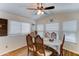 Cozy dining area featuring a ceiling fan, wood flooring, and large windows at 111 S Greenfield Rd # 400, Mesa, AZ 85206