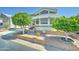 Well-maintained home exterior with desert landscaping, featuring manicured trees and gravel ground cover at 111 S Greenfield Rd # 400, Mesa, AZ 85206