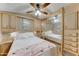 Comfortable main bedroom with ample storage, mirrored closets, and a ceiling fan for a relaxing retreat at 111 S Greenfield Rd # 400, Mesa, AZ 85206