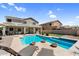 This backyard features a pool and spa, lounge chairs, a covered patio, and desert landscaping at 11225 E Sylvan Ave, Mesa, AZ 85212