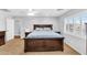 Spacious bedroom featuring carpet, neutral walls, and a large dark wood bed frame and matching side tables at 11225 E Sylvan Ave, Mesa, AZ 85212