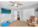 Bedroom with a ceiling fan, as well as a closet with sliding doors, and a window with plantation shutters at 11225 E Sylvan Ave, Mesa, AZ 85212