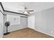 Empty bedroom features carpet, a ceiling fan, a window with plantation shutters, and a closet with sliding doors at 11225 E Sylvan Ave, Mesa, AZ 85212