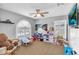 Bedroom featuring carpet and a window with an arched top, as well as a ceiling fan at 11225 E Sylvan Ave, Mesa, AZ 85212