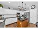 Bright kitchen featuring white cabinets, granite counters, stainless appliances, and center island at 11225 E Sylvan Ave, Mesa, AZ 85212