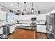 A well-appointed kitchen with white cabinets, granite countertops, stainless appliances, and center island at 11225 E Sylvan Ave, Mesa, AZ 85212