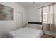 Bright bedroom features neutral walls, decor, and wood floors for a modern touch at 11979 W Pierce St, Avondale, AZ 85323