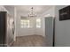 This bright dining area boasts wood floors, modern light fixture, and ample natural light at 11979 W Pierce St, Avondale, AZ 85323