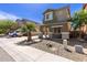 Two-story home featuring desert landscaping, a small palm tree, and a covered front porch at 11979 W Pierce St, Avondale, AZ 85323