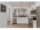 Bright white kitchen featuring stainless steel appliances and an open design that connects to the living room at 11979 W Pierce St, Avondale, AZ 85323