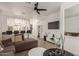 Open-concept living room showcasing a large sofa, modern decor, and a view into the kitchen and staircase at 11979 W Pierce St, Avondale, AZ 85323