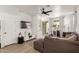 Bright living room with a modern ceiling fan, stylish decor, and sliding glass doors to the backyard at 11979 W Pierce St, Avondale, AZ 85323