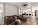 Spacious living room featuring a comfortable sectional sofa, modern decor, and open access to the kitchen at 11979 W Pierce St, Avondale, AZ 85323