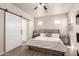 Spacious main bedroom featuring a sliding barn door, neutral tones, and ample natural light at 11979 W Pierce St, Avondale, AZ 85323