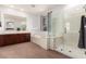 Bright bathroom featuring a large vanity, soaking tub and walk-in glass shower at 12911 W Campbell Ave, Litchfield Park, AZ 85340
