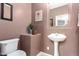 Powder room featuring a pedestal sink and stylish accents at 12911 W Campbell Ave, Litchfield Park, AZ 85340