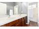 Bathroom featuring a double vanity, wood cabinets and tub/shower combo at 12911 W Campbell Ave, Litchfield Park, AZ 85340