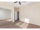 Bedroom featuring carpet, a ceiling fan and mirrored closet doors at 12911 W Campbell Ave, Litchfield Park, AZ 85340