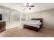 Bedroom with hardwood flooring, ceiling fan and a three-window view at 12911 W Campbell Ave, Litchfield Park, AZ 85340