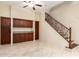 Bonus room with tile flooring, storage and staircase with iron handrail at 12911 W Campbell Ave, Litchfield Park, AZ 85340