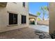 Back exterior of the house featuring the patio, pavers and a detached garage at 12911 W Campbell Ave, Litchfield Park, AZ 85340