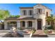 Charming two-story home featuring a stucco exterior, tile roof, and gated driveway entrance at 12911 W Campbell Ave, Litchfield Park, AZ 85340