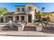 Beautiful stucco home featuring a covered gated drive and stone walkway leading to the front door at 12911 W Campbell Ave, Litchfield Park, AZ 85340