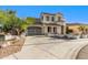 Stucco home with gated drive, tile roof, desert landscaping, and a curved entrance at 12911 W Campbell Ave, Litchfield Park, AZ 85340