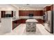 Gourmet kitchen with custom cabinetry, island, and stainless steel appliances at 12911 W Campbell Ave, Litchfield Park, AZ 85340