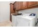 A laundry room with washer, dryer and cabinets for storage space at 12911 W Campbell Ave, Litchfield Park, AZ 85340