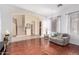 Open-concept living room featuring hardwood floors, neutral walls, and seamless access to staircase at 12911 W Campbell Ave, Litchfield Park, AZ 85340
