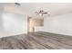 Spacious living room with white walls, ceiling fan and vinyl plank flooring at 12911 W Campbell Ave, Litchfield Park, AZ 85340