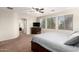 Spacious main bedroom features a ceiling fan and a three-window view at 12911 W Campbell Ave, Litchfield Park, AZ 85340