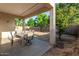 Relaxing covered patio with a patio set, perfect for entertaining guests outdoors at 12911 W Campbell Ave, Litchfield Park, AZ 85340