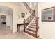 View of the staircase featuring wood railing, tiled steps, and an ornate table at 12911 W Campbell Ave, Litchfield Park, AZ 85340