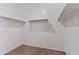 Walk-in closet with carpeted flooring, white walls, and metal clothing racks at 1314 W Kennedy Ave, Coolidge, AZ 85128